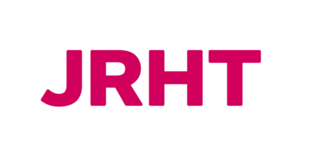 JRHT logo in bold pink letters on a white background, representing community support at York Pride.