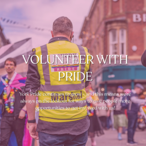 York Pride volunteer in yellow vest at colourful street event, promoting involvement and community spirit.