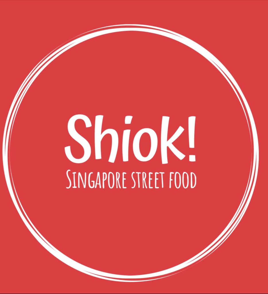 Shiok! Singapore Street Food logo in bold white text on a red background with a white circular border.