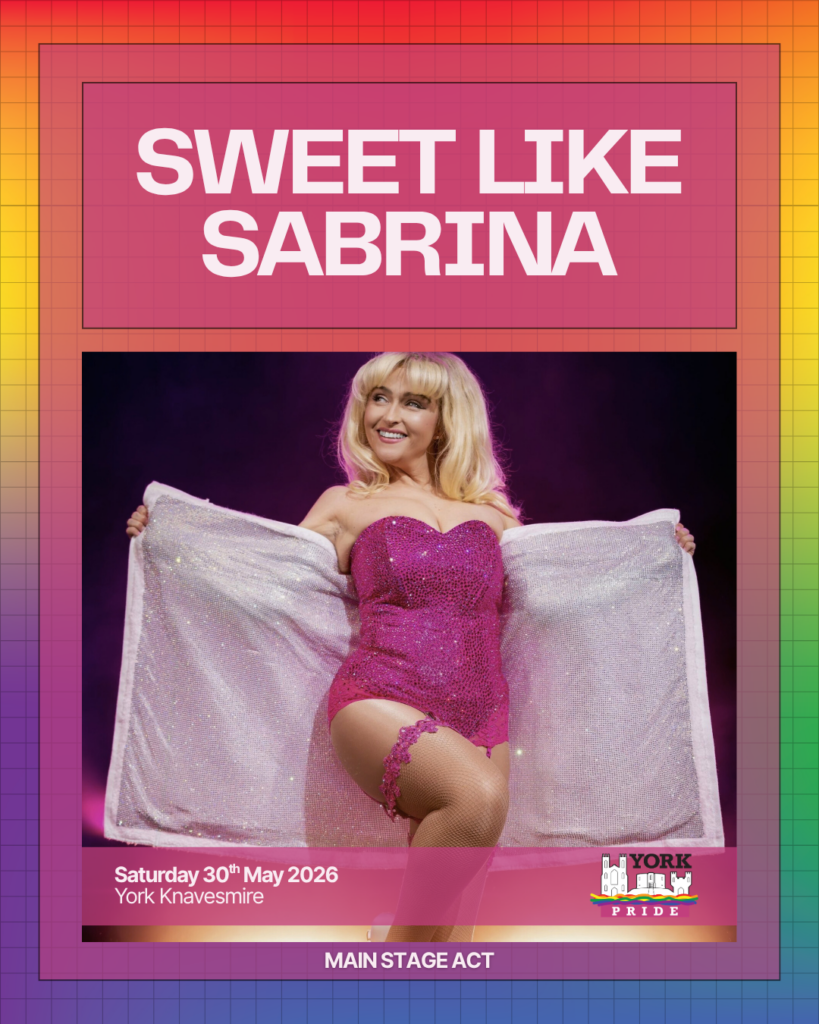 Performer in sparkly pink outfit holding cape at York Pride 2026 on 30th May, York Knavesmire. Main stage act.
