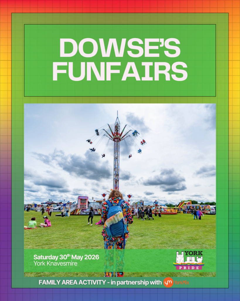 ```markdown
Person at York Pride funfair on a cloudy day with rides in the background, promoting family activities, May 2026.
```